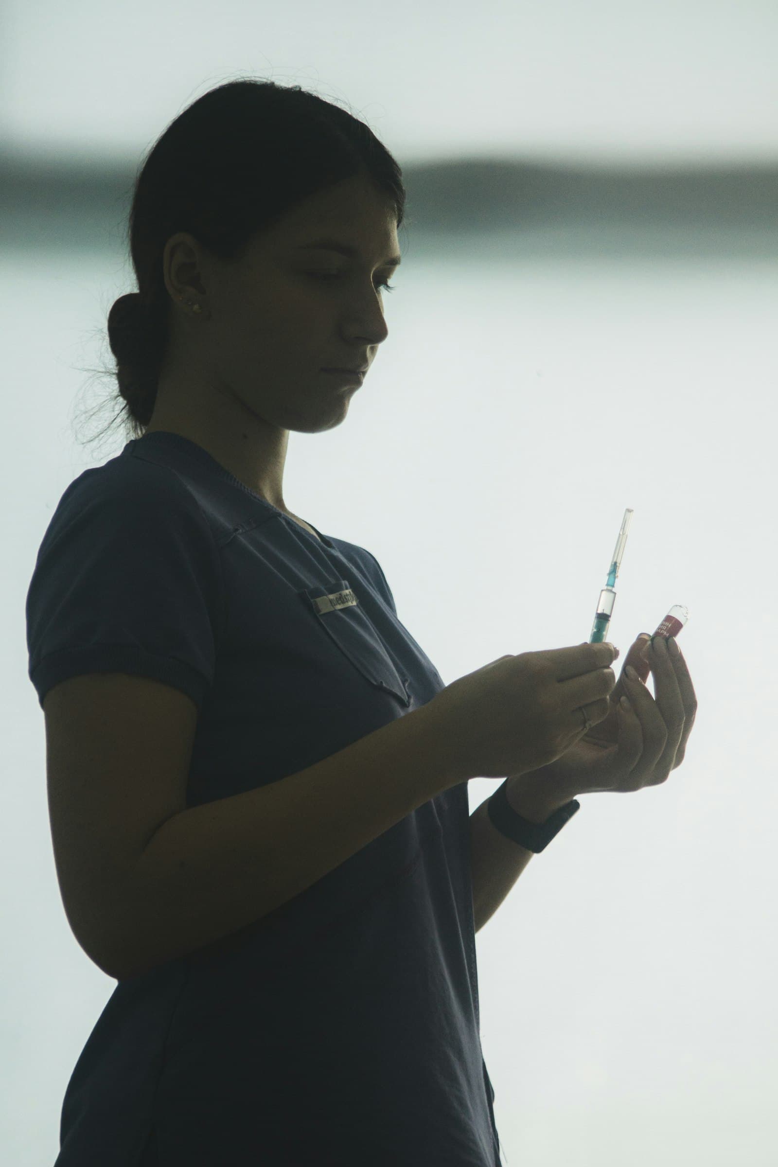 A nurse preparing an injection