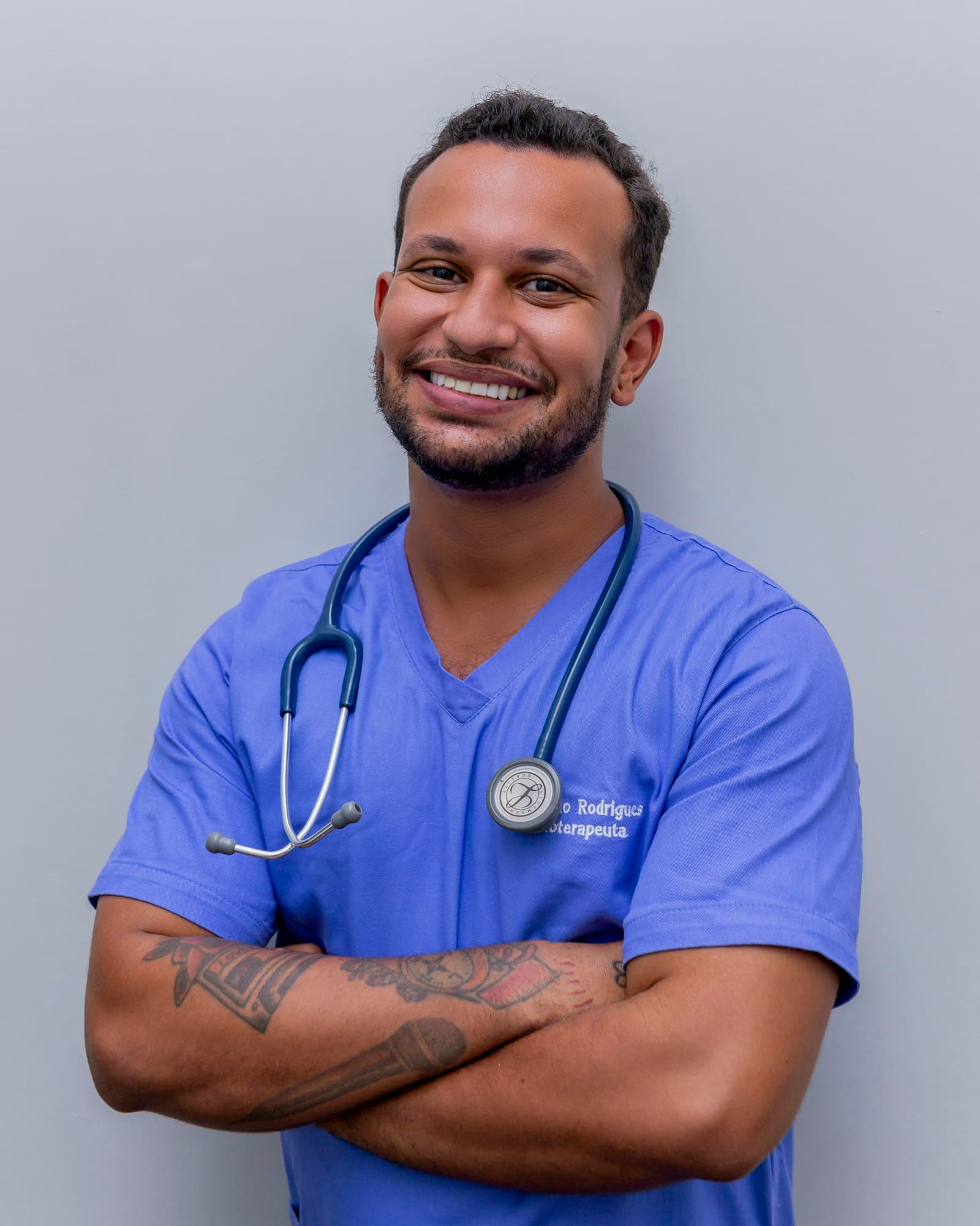 A male nurse in blue scrubs
